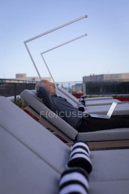 Uomo d'affari che riposa su un lettino nei locali dell'hotel — Foto stock