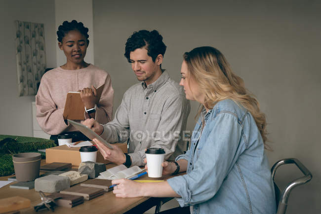 Executives discussing over digital tablet in office — Stock Photo