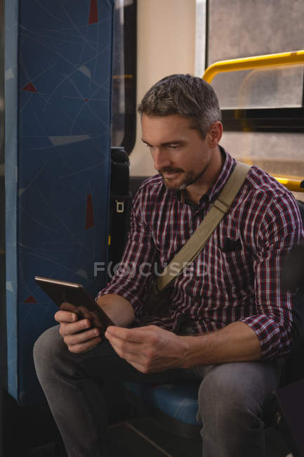 Schöner Mann mit digitalem Tablet in Straßenbahn unterwegs — Stockfoto