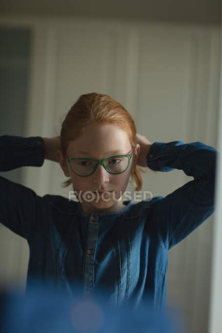 Reflection of girl looking into mirror at home — Stock Photo