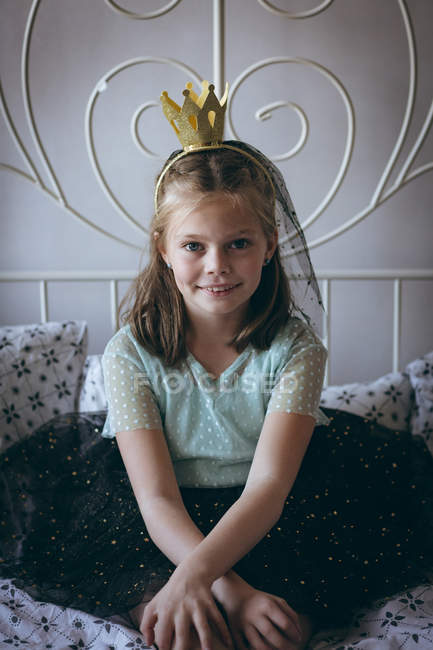 Happy girl with tiara on head in bedroom — Stock Photo