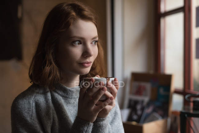Thoughtful woman having sweet food at home — Stock Photo