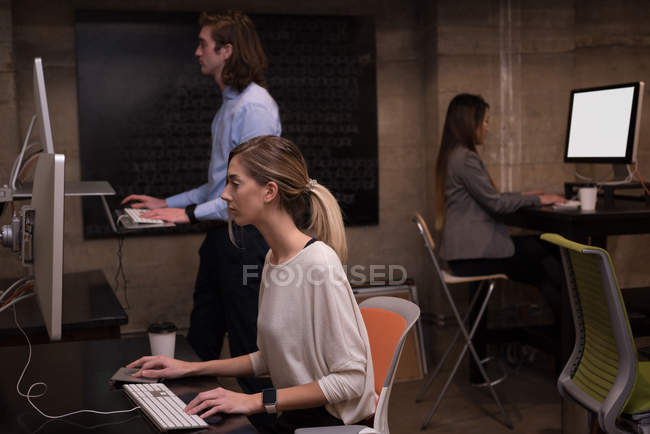 Collègues d'affaires travaillant sur l'ordinateur dans le bureau — Photo de stock