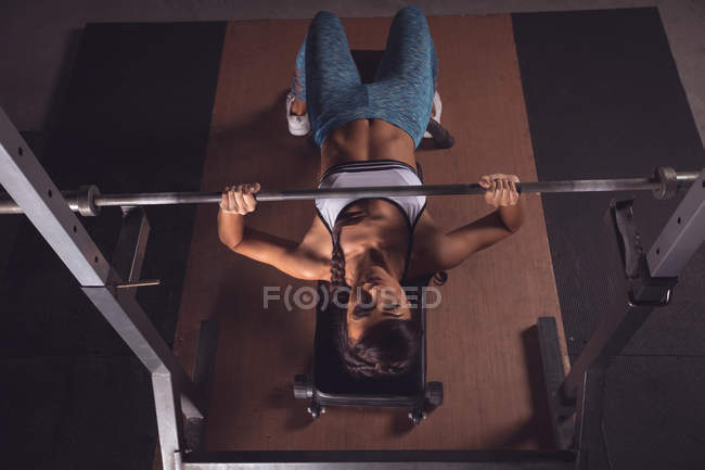 Fitte Frau beim Hantelheben in der Turnhalle — Stockfoto