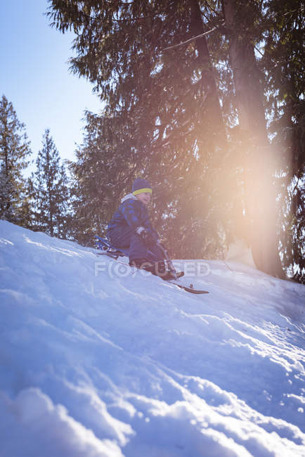 Cute girl playing in sled during winter — Stock Photo
