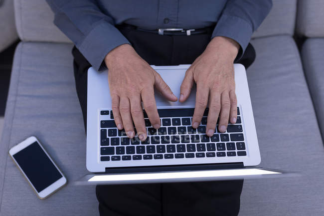 Mid section of businessman using a laptop — Stock Photo