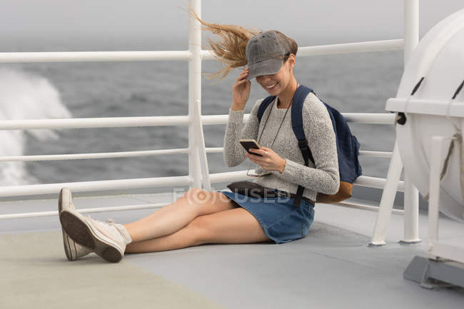 Femme utilisant un téléphone portable téléphone portable sur un bateau de croisière — Photo de stock