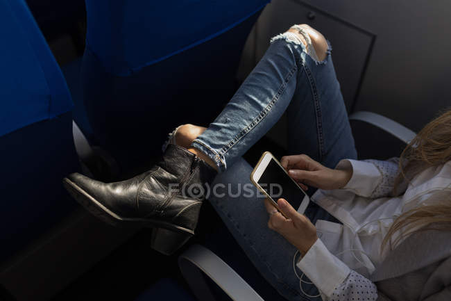 Low section of woman using mobile phone in cruise ship — Stock Photo