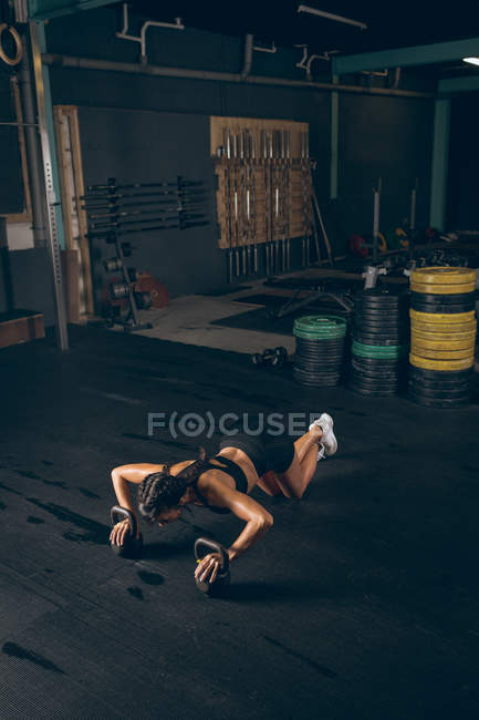Fitte Frau trainiert mit Kettlebell im Fitnessstudio — Stockfoto