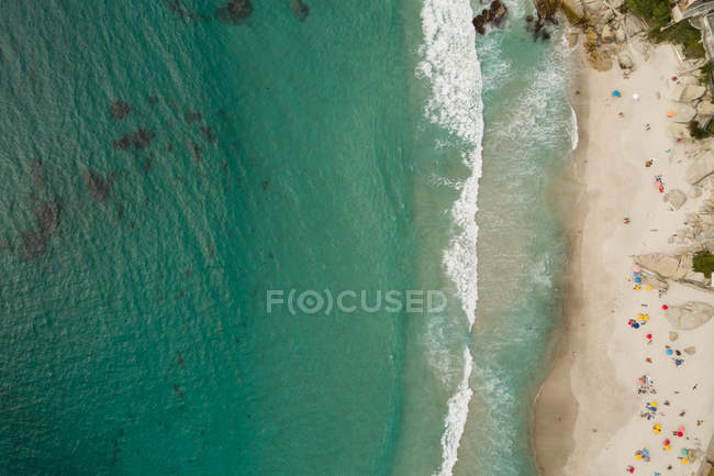 Veduta aerea dei turisti prendere il sole in spiaggia in una giornata di sole — Foto stock