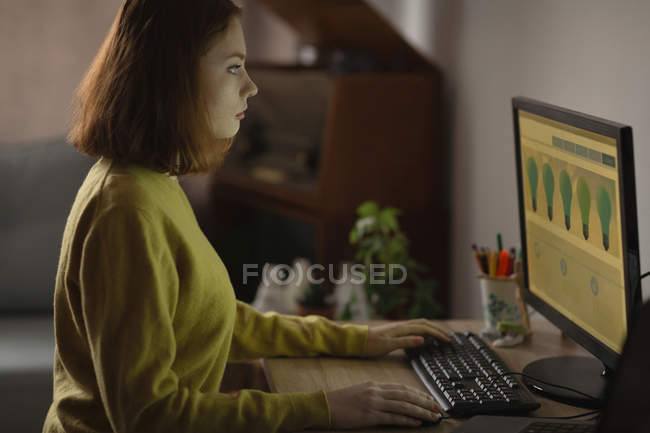 Giovane donna che utilizza il personal computer a casa — Foto stock