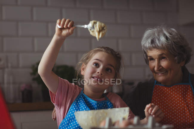 Бабуся і онука готують печиво на кухні вдома — стокове фото