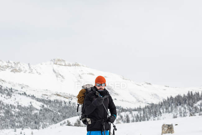 Чоловічий альпініст тримає лижний полюс на закритій горі взимку — стокове фото