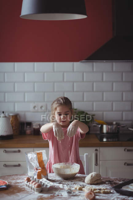 Little girl preparing cookies in kitchen at home — Stock Photo