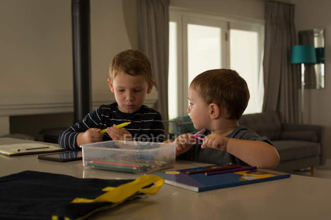 Irmãos fazendo seus trabalhos de casa juntos em casa — Fotografia de Stock