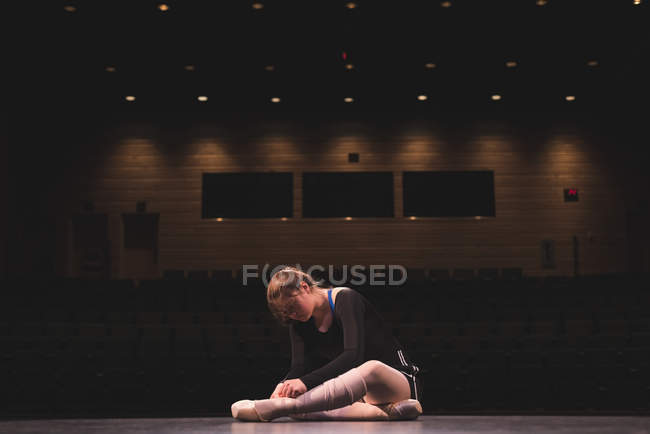 Ballet dancer wearing ballet shoe on stage at theatre — Stock Photo