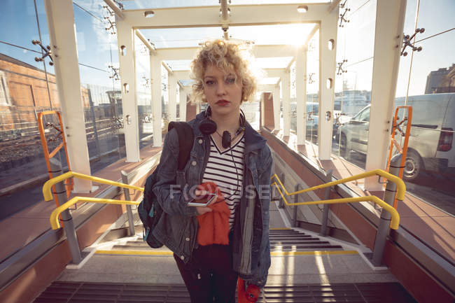 Young woman moving upstairs in city — Stock Photo