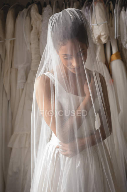 Sensual mixed-race bride in wedding dress and veil — Stock Photo