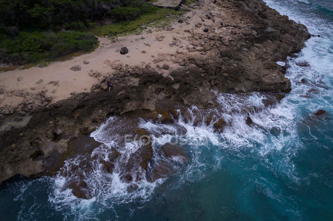Aerial of rocky coast along the turquoise sea — Stock Photo