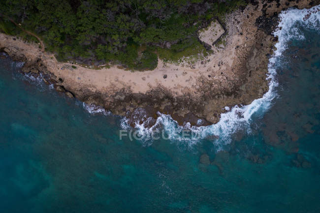 Aerial of rocky coast along the turquoise sea — Stock Photo