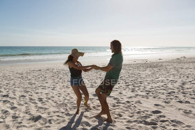 Coppia si diverte in spiaggia in una giornata di sole — Foto stock