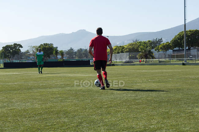 Player playing football soccer game on sports field — Stock Photo