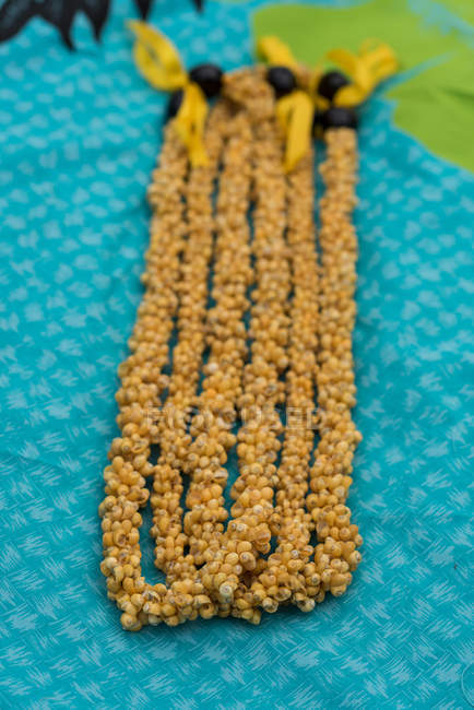 Close-up of lei garland arranged on a mat — Stock Photo