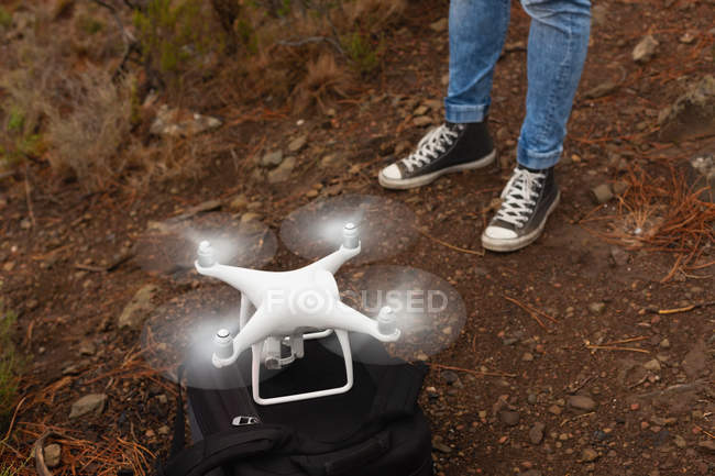 Baixa seção do homem operando um drone voador — Fotografia de Stock