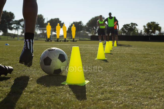 focused 206525026 stock photo soccer player dribbling ball cones