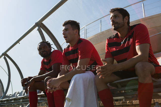 Football player watching the football match from dugout — Stock Photo