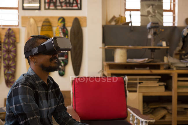 Man using virtual reality headset in workshop — Stock Photo