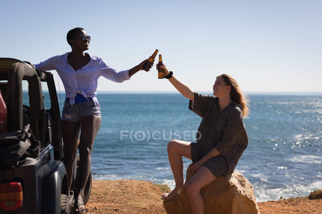 Female friends having fun in the beach on a sunny day — Stock Photo