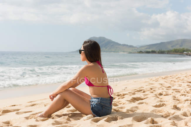 Frau entspannt sich an einem sonnigen Tag am Strand — Stockfoto