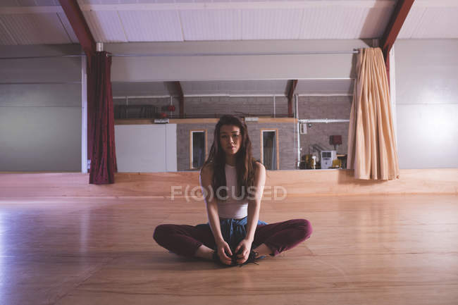 Young female dancer relaxing in dance studio — Stock Photo