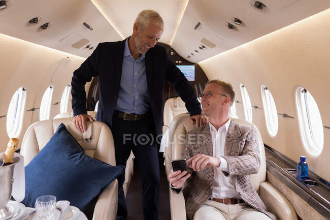 Business people boarding in private jet at terminal — Stock Photo