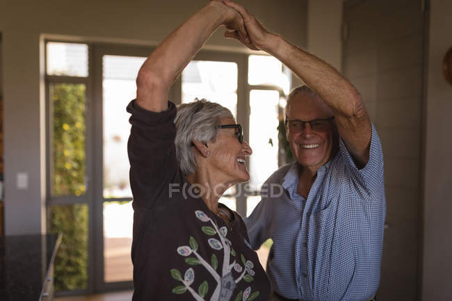 Beautiful senior couple dancing together at home — Stock Photo