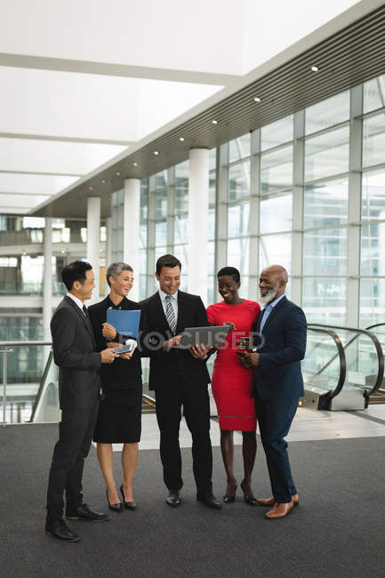 Group of happy business people interacting with each other in the office — Stock Photo
