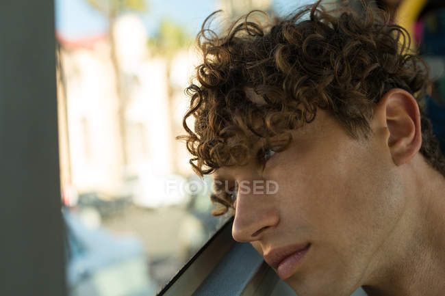 Close-up of thoughtful young man travelling in the bus — Stock Photo