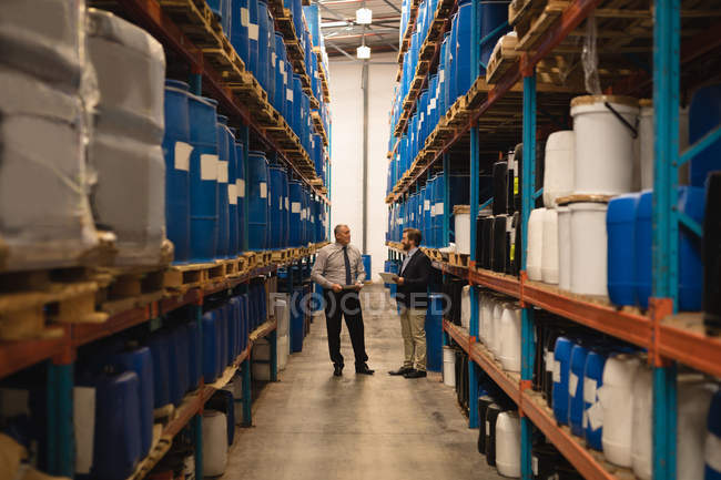 Staff interacting with each other in warehouse — Stock Photo