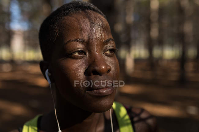 Close-up of exhausted female athlete taking a break — Stock Photo