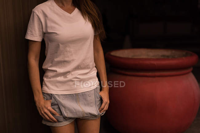 Mid section of woman standing with hands in pocket — Stock Photo