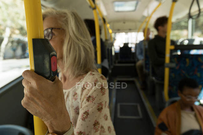 Senior woman travelling in the bus — Stock Photo