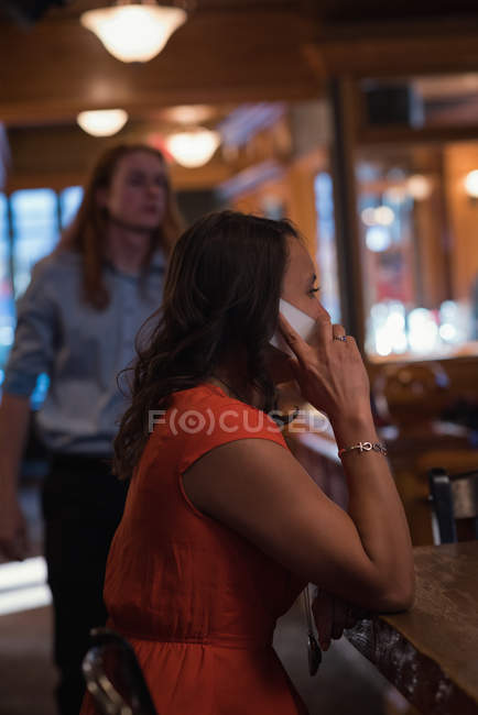 Woman talking on mobile phone in the night club — Stock Photo