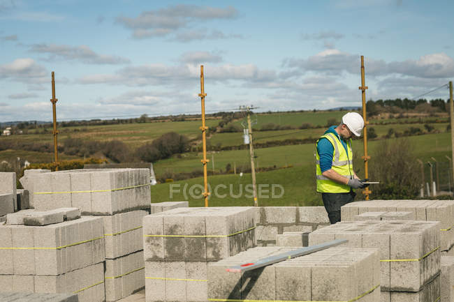 Engineer using digital tablet at the construction site — Stock Photo