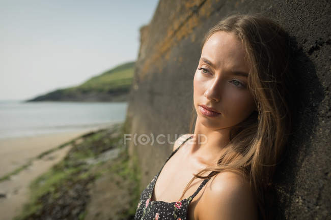 Close-up of beautiful woman standing against the rock formation — Stock Photo