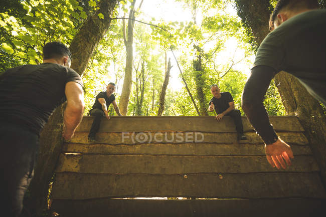 Fit men training over obstacle course at boot camp — Stock Photo