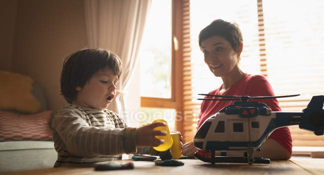 Mother playing with son on the table at home — Stock Photo
