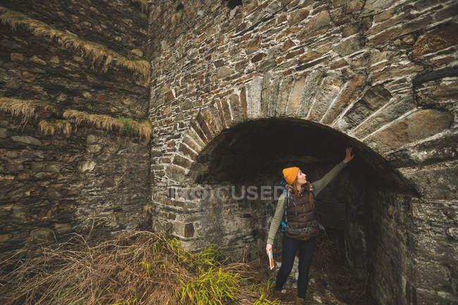 Young female hiker touching the wall — Stock Photo