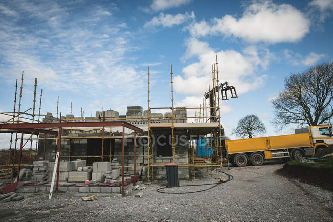 Yellow truck at the construction site — Stock Photo