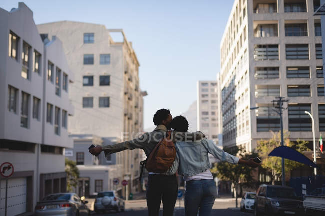 Rear view of twins siblings standing in city street — Stock Photo
